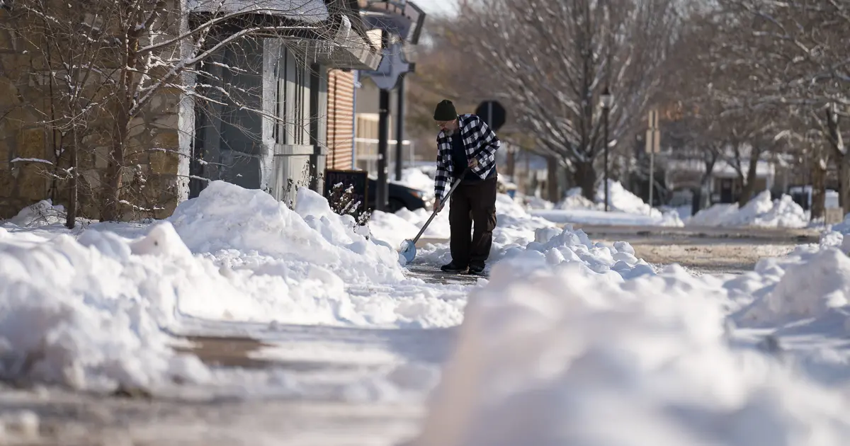 Person shoveling snow off sidewalk