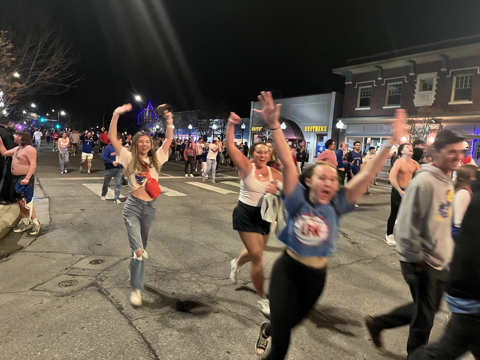 Fans pour down the street toward 9th and Massachusetts to celebrate a win during the 2022 NCAA tournament.