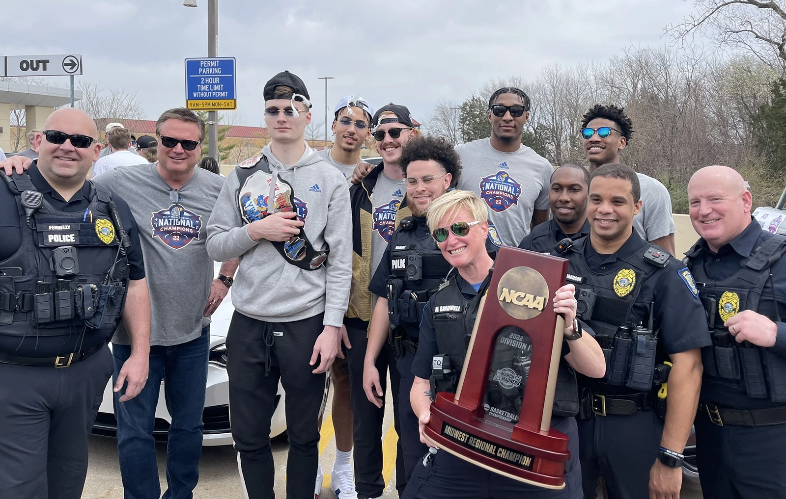 The 2022 National Champions, along with Coach Bill Self, are gracious enough to pose for a photo with officers.