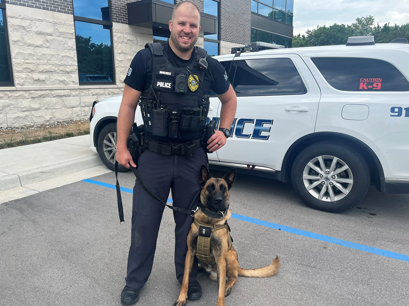 Shadow and Doncouse standing by patrol vehicle